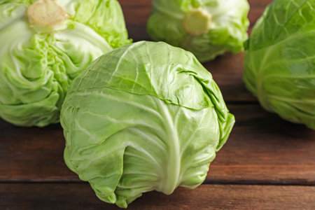 Fresh whole cabbages on wooden table, closeupの写真素材