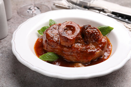 Traditional ossobuco dish with beef steak served on grey table, closeupの写真素材