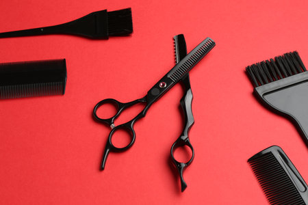 Different hairdresser's tools on red background, above viewの写真素材