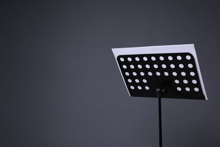 Note stand with music sheets on grey background, space for textの写真素材