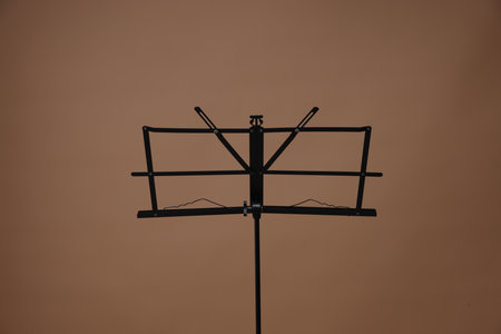 One empty note stand on dark beige backgroundの写真素材