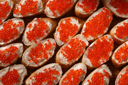 Buffet menu. Sandwiches with red caviar on table, top viewの写真素材