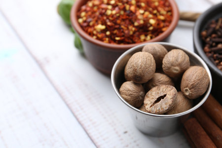 Different aromatic spices on white wooden table, closeup. Space for textの写真素材