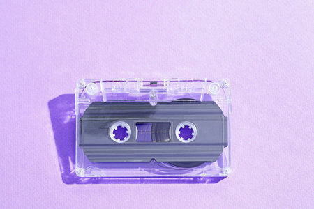 One audio cassette with magnetic tape on violet background, top viewの写真素材