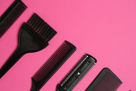 Different hairdresser's tools on pink background, flat lay. Space for textの写真素材