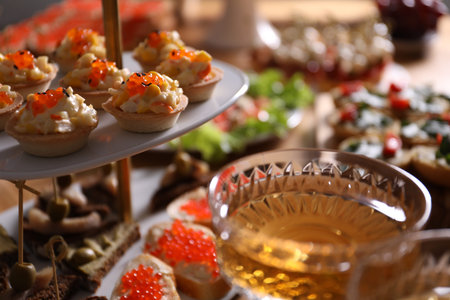 Buffet menu. Tasty stuffed tartlets and sparkling wine on table, closeup