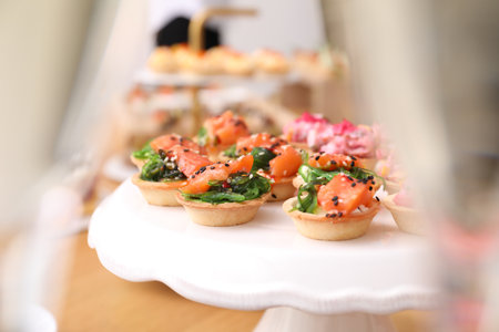 Buffet menu. Tasty stuffed tartlets on stand, closeupの写真素材