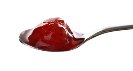 Tasty strawberry jam in spoon isolated on whiteの写真素材