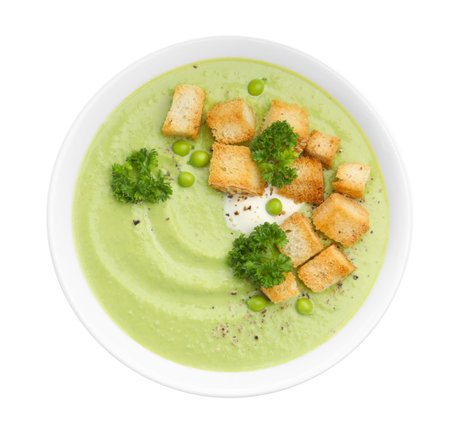 Tasty pea cream soup with croutons and broccoli isolated on white, top viewの写真素材