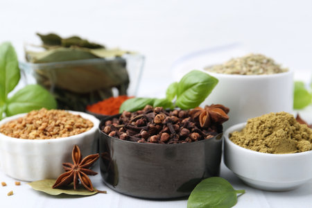 Different aromatic spices on white table, closeupの写真素材