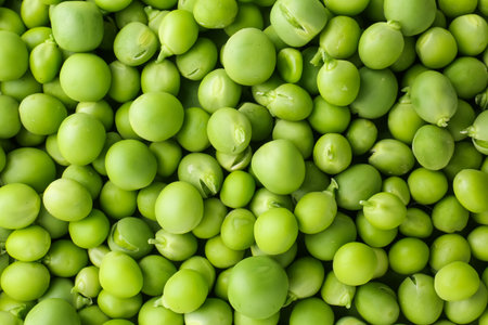 Pile of fresh green peas as background, top viewの写真素材