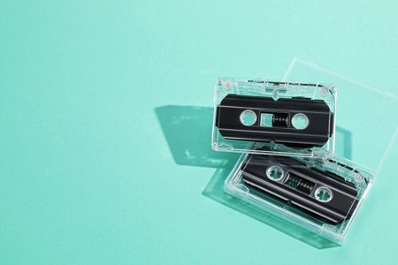 Audio cassettes with magnetic tapes on turquoise background, above view. Space for textの写真素材
