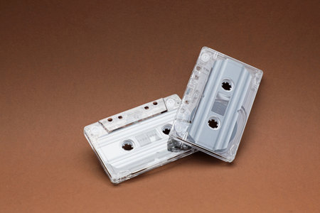 Audio cassettes with magnetic tapes on brown backgroundの写真素材
