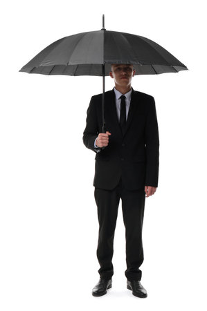 Man in suit with black umbrella on white backgroundの写真素材