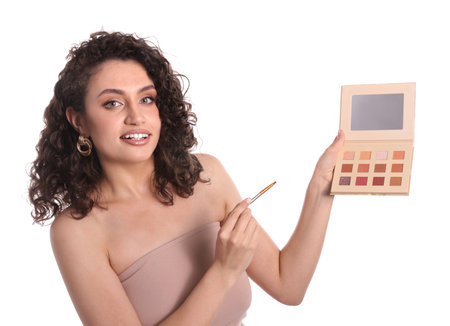 Woman with eyeshadow palette and brush on white backgroundの写真素材