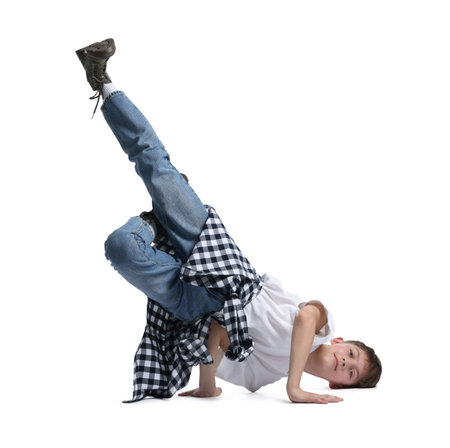 Boy in stylish clothes dancing on white background