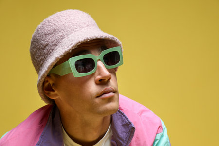 Fashionable portrait of handsome man in stylish outfit on color background, space for textの写真素材