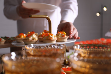 Buffet menu. Woman taking tartlet from table, closeup