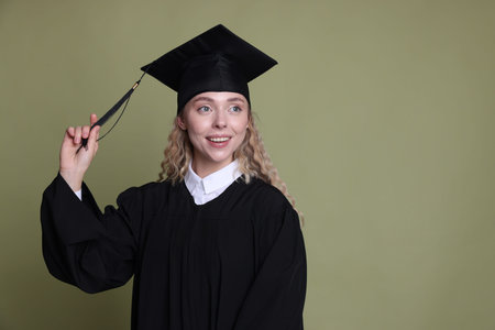 Happy student after graduation on green background. Space for text