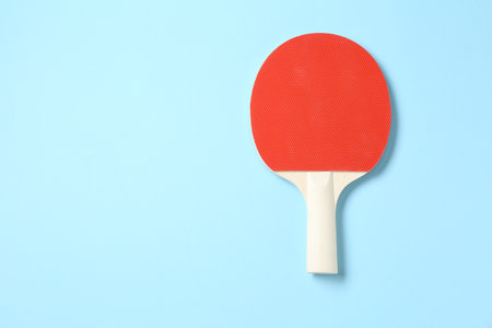 One ping pong racket on light blue background, top view. Space for textの写真素材