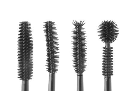Different mascara brushes on white background, set