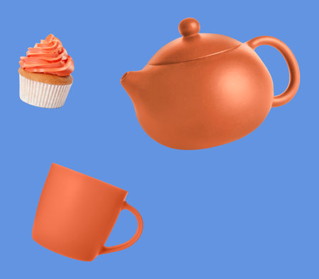 Dark orange teapot, cup and cupcake in air against pastel blue backgroundの写真素材