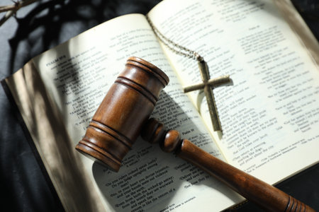 Judge's gavel, Bible and cross on black table, top viewの写真素材