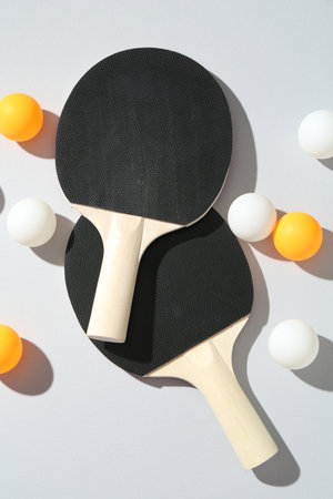 Ping pong rackets and balls on light background, flat layの写真素材