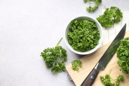 Fresh parsley and knife on light table, flat lay. Space for textの写真素材
