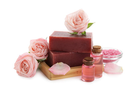 Aromatic soap bar, roses and cosmetic products isolated on whiteの写真素材