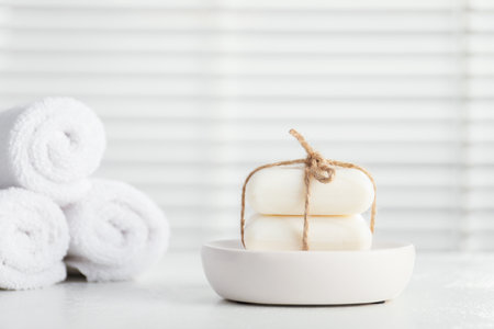 Soap bars and towels on white table indoors, closeupの写真素材