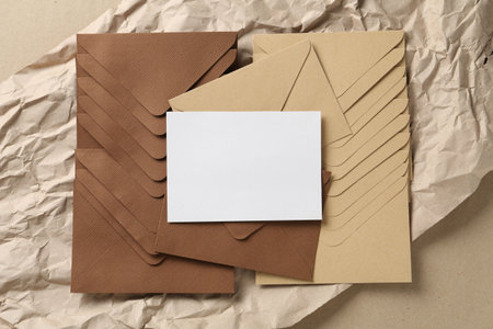 Blank invitation card, envelopes and parchment paper on carton, top view. Space for designの写真素材