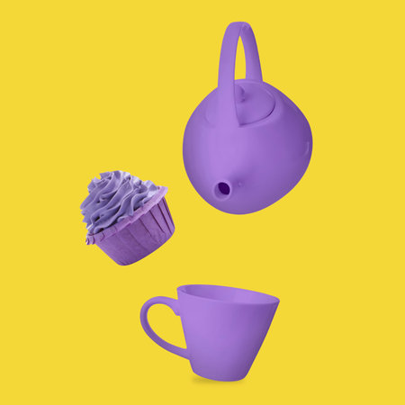 Violet teapot, cup and cupcake in air against yellow backgroundの写真素材