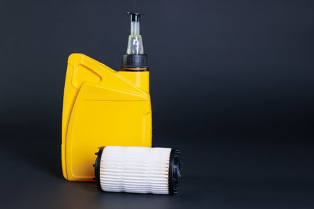 Motor oil in plastic canister and filter on dark gray background, space for textの写真素材