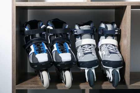 Pairs of roller skates in shelving unit, closeup