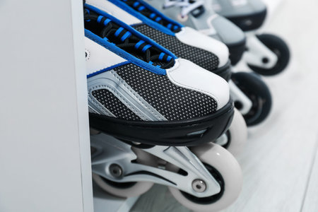 Pairs of roller skates in shelving unit, closeup
