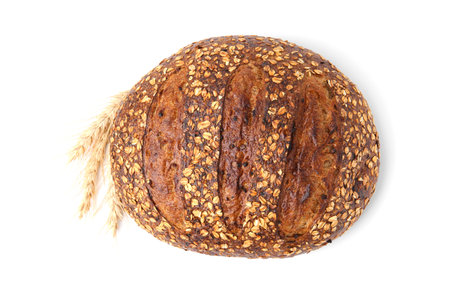 Fresh bread with oat flakes and spikes isolated on white, top view
