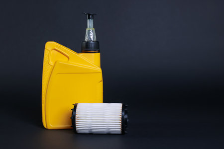 Motor oil in plastic canister and filter on dark grey background, space for textの写真素材