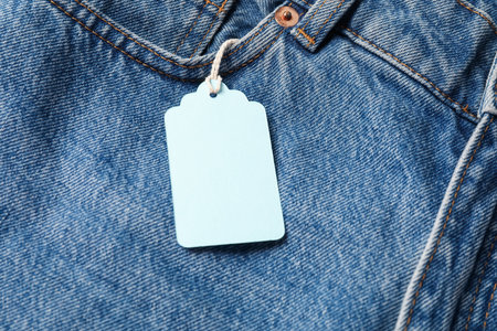 Cardboard tag on blue jeans, above viewの写真素材