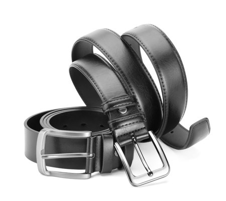 Two black leather belts isolated on whiteの写真素材