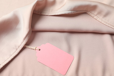 Cardboard tag on silk garment, top viewの写真素材