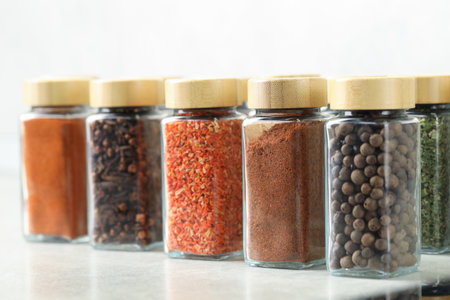 Many different aromatic spices in jars on table indoors, closeupの写真素材