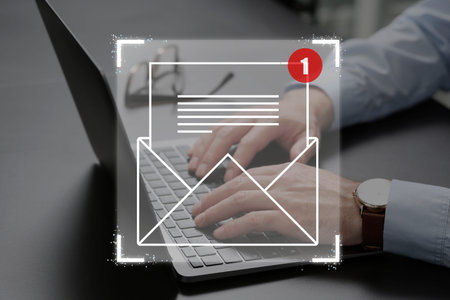 Email marketing, new message notification. Man using laptop at table, closeupの写真素材