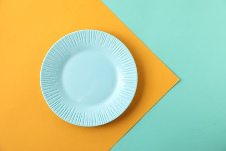One empty plate on color background, top view. Space for textの写真素材