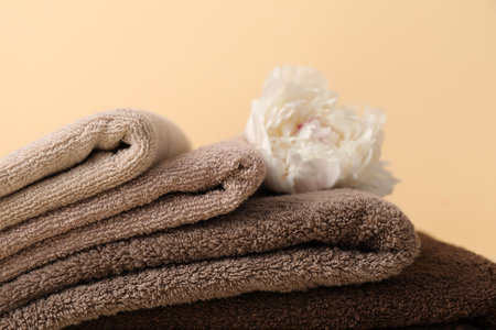 Soft towels and peony flower on beige background, closeupの写真素材