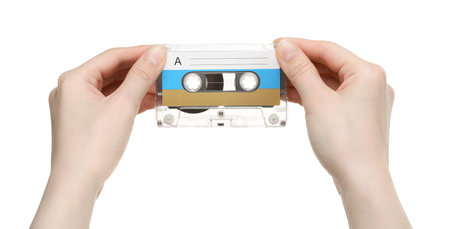 Woman holding audio cassette with blank label on white background, closeupの写真素材