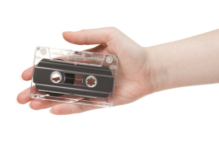 Woman with audio cassette on white background, closeupの写真素材