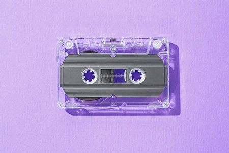One audio cassette with magnetic tape on violet background, top viewの写真素材