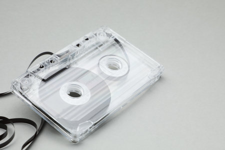 One audio cassette with magnetic tape on gray background, closeupの写真素材