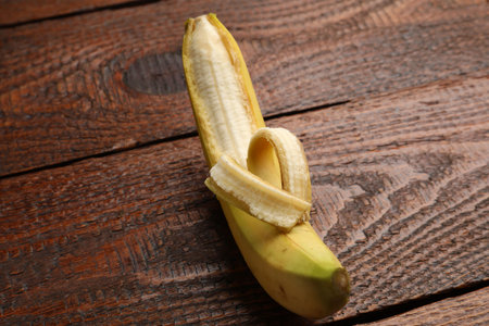 Banana with heart made of peel on wooden table, above viewの写真素材